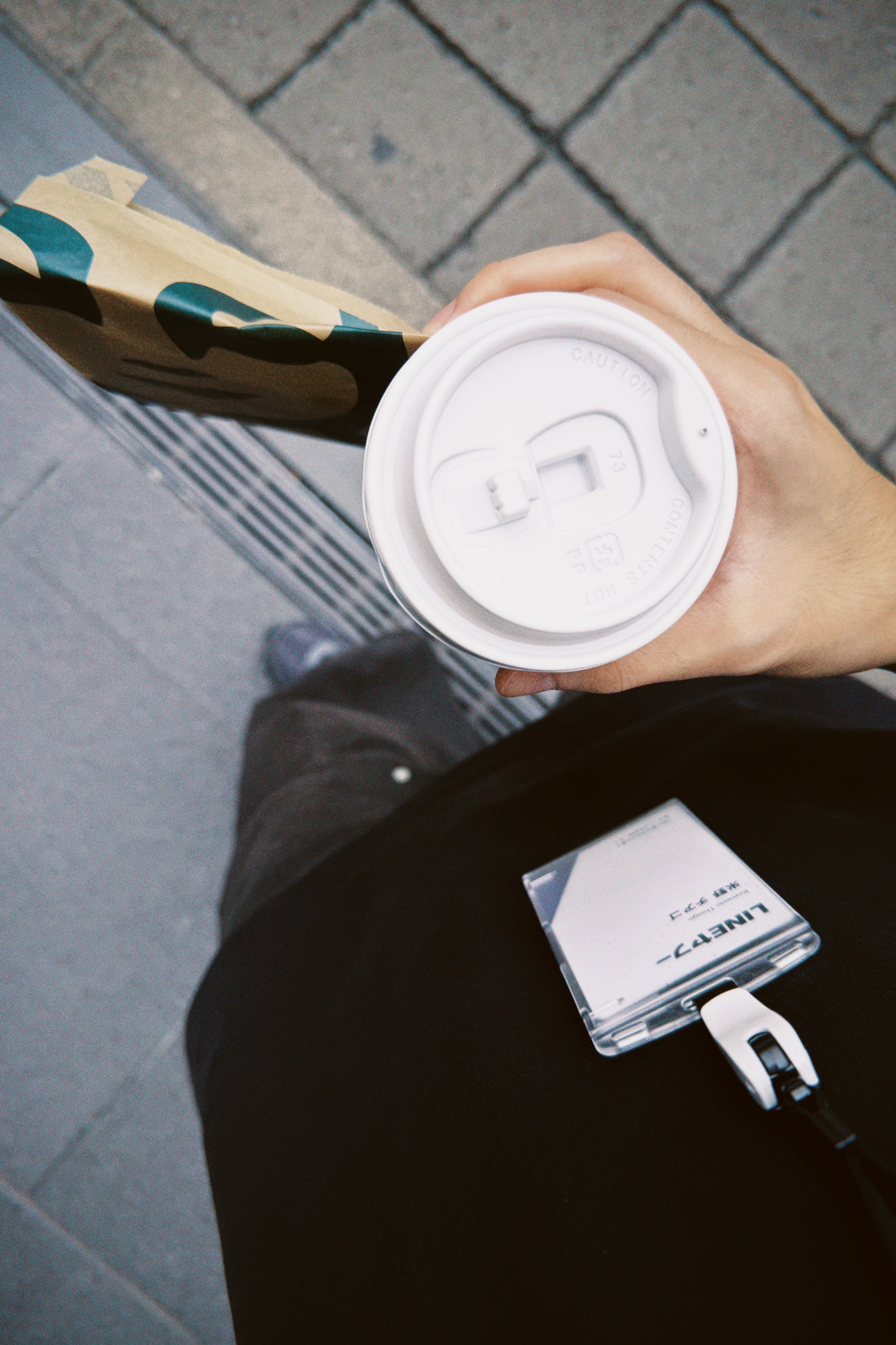 Coffee and a LINE visitor badge carried on the walk to the Fukuoka office
